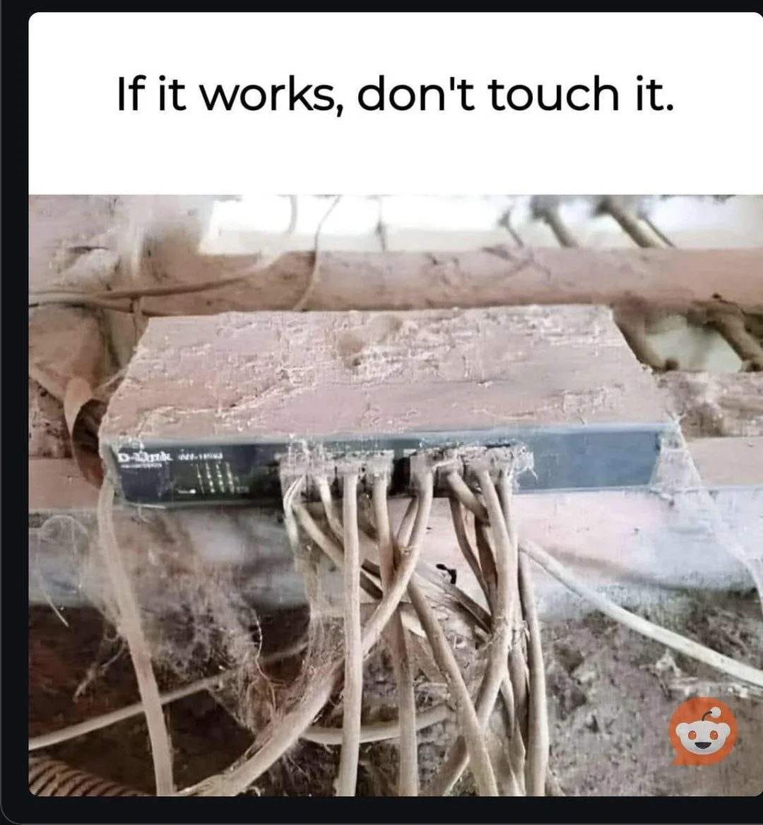 Meme: a dusty, cobweb-covered network switch with the caption If it works, don't touch it